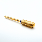 Gold cylindrical tool with textured end on a white background
