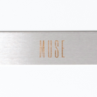 A straight metal nail file with 'MUSE' inscribed on the side.